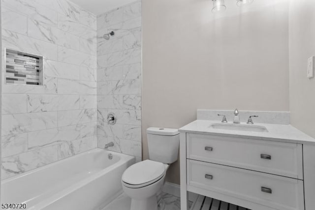 bathroom featuring marble finish floor, toilet, washtub / shower combination, vanity, and baseboards