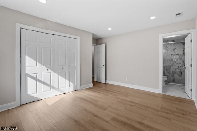 unfurnished bedroom featuring visible vents, light wood-style flooring, and baseboards