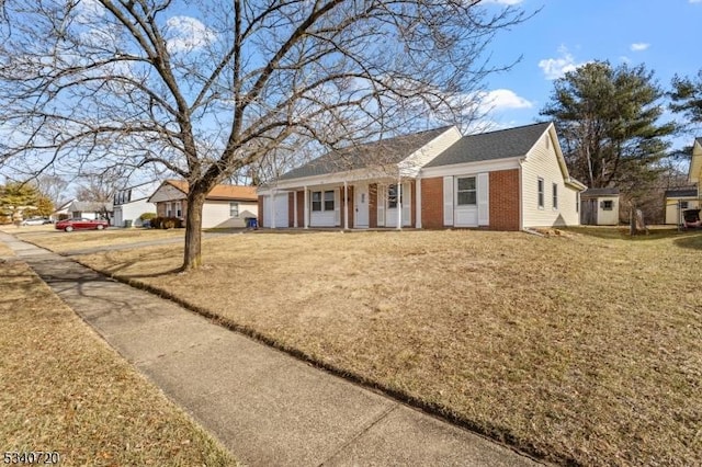 single story home featuring a garage, brick siding, and a front lawn