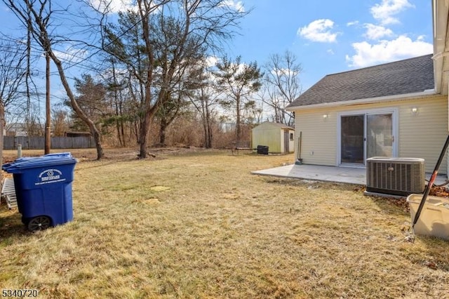 view of yard featuring a storage shed, an outdoor structure, cooling unit, and a patio