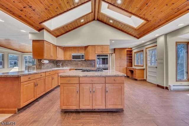 kitchen featuring stainless steel appliances, a skylight, a baseboard radiator, and decorative backsplash