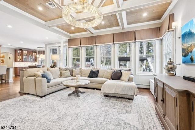 interior space with plenty of natural light, coffered ceiling, and wood finished floors