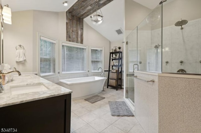 bathroom with double vanity, lofted ceiling with beams, tile patterned floors, a freestanding tub, and a shower stall