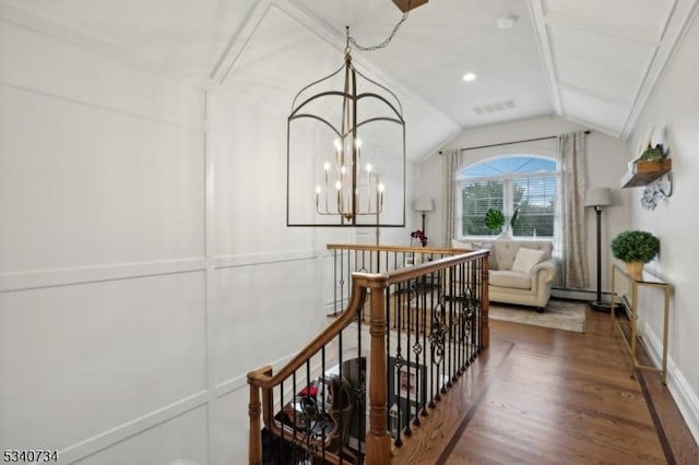 corridor featuring visible vents, an inviting chandelier, vaulted ceiling, an upstairs landing, and wood finished floors