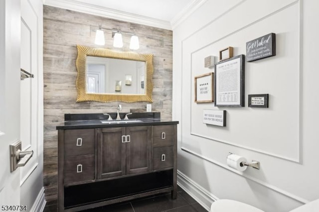 bathroom featuring baseboards, toilet, ornamental molding, tile patterned floors, and vanity