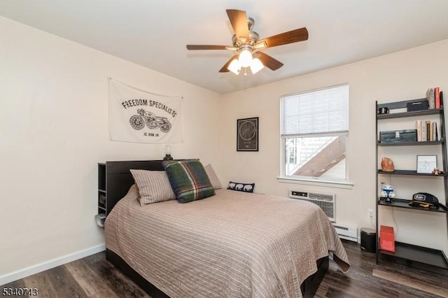 bedroom with ceiling fan, dark wood-style flooring, baseboards, baseboard heating, and a wall mounted air conditioner