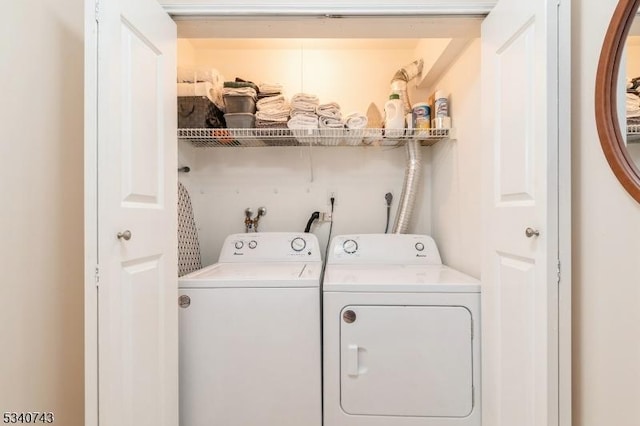 washroom featuring laundry area and washing machine and dryer