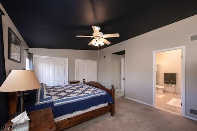 bedroom featuring multiple closets, carpet flooring, visible vents, and baseboards