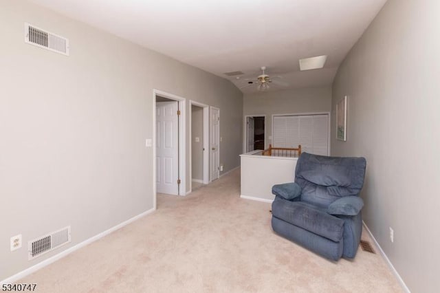 sitting room featuring ceiling fan, visible vents, baseboards, and light colored carpet