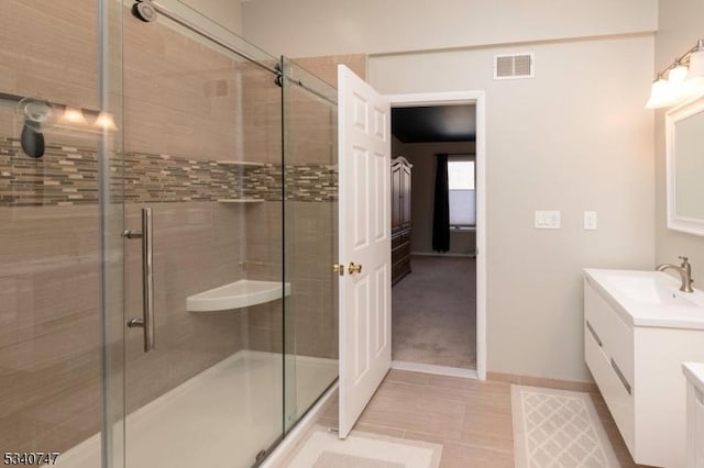 full bath featuring a shower stall, visible vents, and vanity