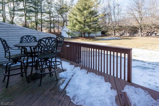 wooden terrace with outdoor dining area