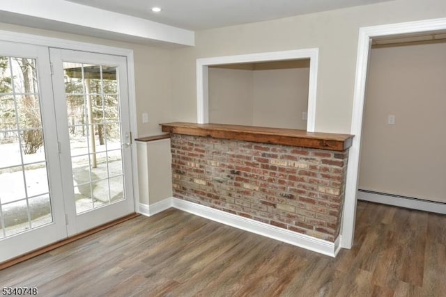 entryway with a baseboard radiator, recessed lighting, baseboards, and wood finished floors