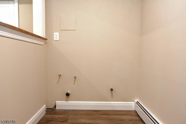 washroom featuring laundry area, baseboards, baseboard heating, and wood finished floors