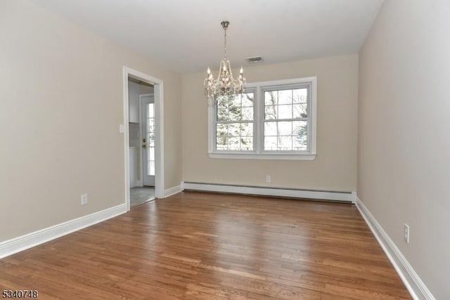 unfurnished room featuring baseboards, a baseboard radiator, visible vents, and wood finished floors