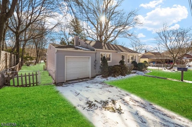 view of front of home with an attached garage, fence, a chimney, and a front lawn