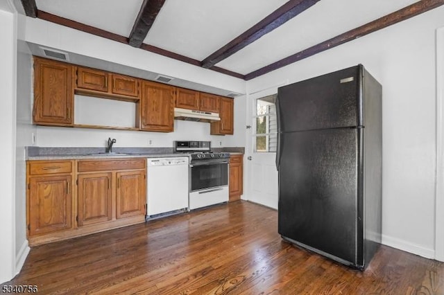 kitchen with freestanding refrigerator, gas range oven, white dishwasher, under cabinet range hood, and a sink