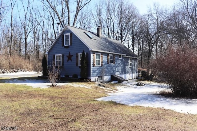 view of home's exterior with a chimney and a lawn