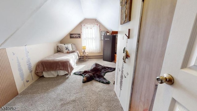 bedroom with vaulted ceiling, carpet floors, and baseboard heating