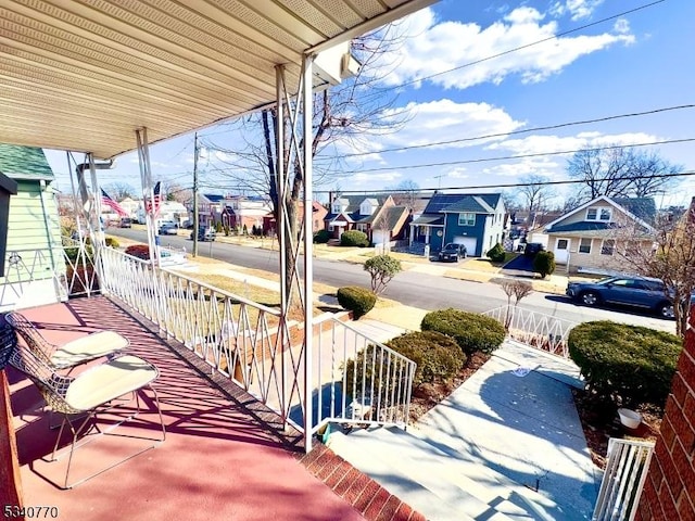 balcony with covered porch and a residential view