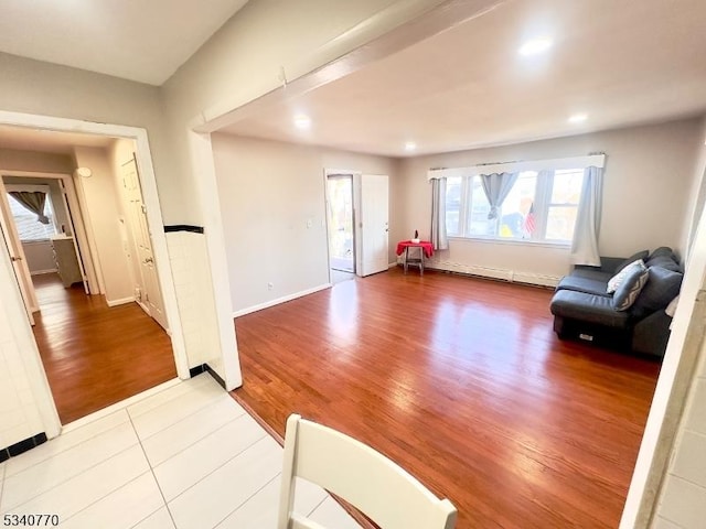 interior space with baseboards, wood finished floors, and recessed lighting