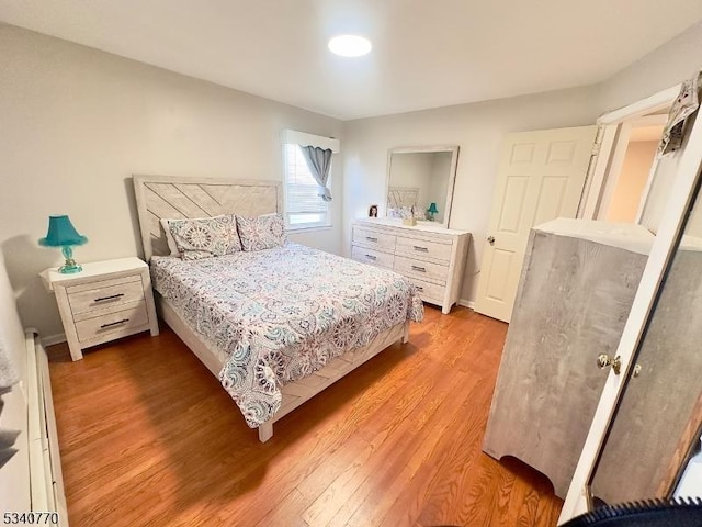 bedroom featuring baseboards and light wood finished floors