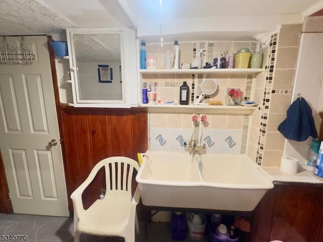 bathroom featuring a sink and decorative backsplash