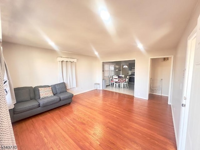 unfurnished living room featuring baseboards and wood finished floors