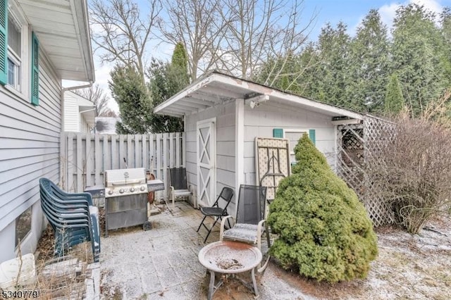 view of patio / terrace featuring fence, grilling area, and an outdoor structure