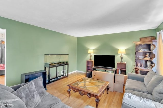 living area featuring wood finished floors and baseboards