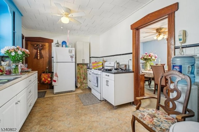 kitchen featuring white appliances, a ceiling fan, and white cabinetry