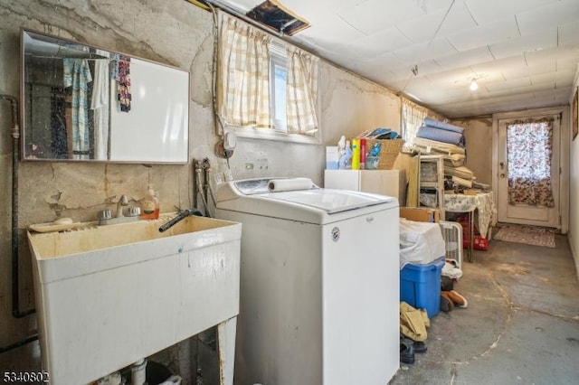 laundry area with laundry area, washer / clothes dryer, and a sink