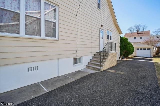 view of side of home with crawl space, an outbuilding, and a garage