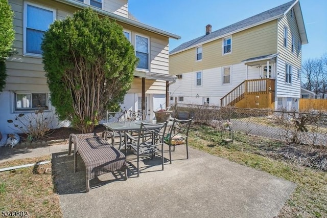 view of patio with outdoor dining space and fence