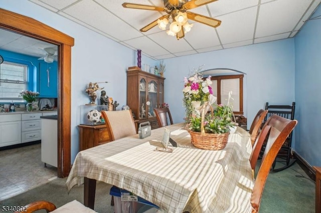 dining room featuring a drop ceiling and ceiling fan