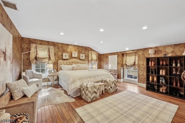 bedroom featuring wallpapered walls, wood finished floors, and recessed lighting