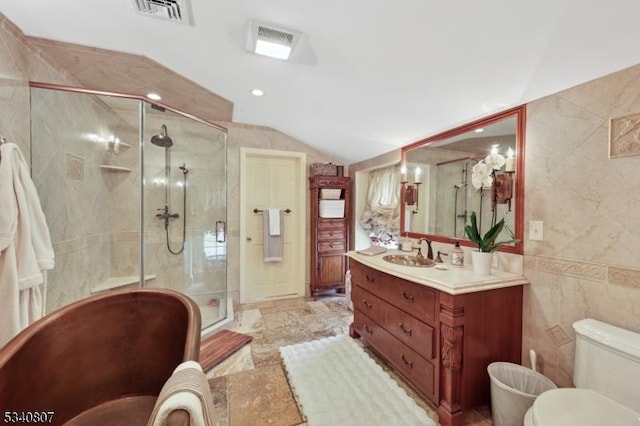 full bath with visible vents, lofted ceiling, toilet, vanity, and tile walls