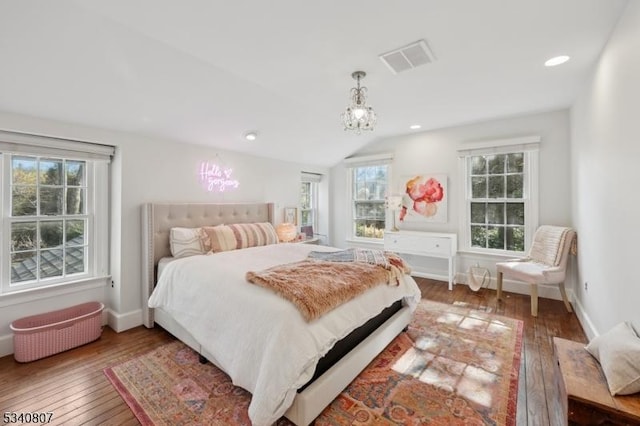 bedroom featuring baseboards, visible vents, hardwood / wood-style floors, and recessed lighting