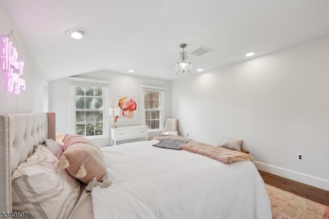 bedroom with vaulted ceiling, recessed lighting, wood finished floors, and baseboards