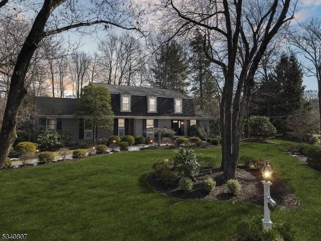 colonial inspired home with a front yard