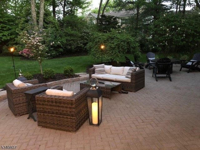 view of patio / terrace with an outdoor living space with a fire pit