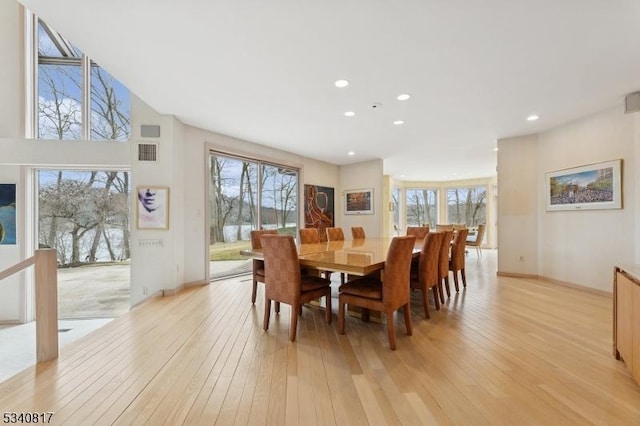 dining room featuring light wood-style floors, a wealth of natural light, visible vents, and recessed lighting