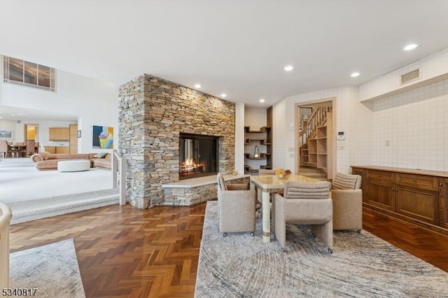 living area with recessed lighting, visible vents, and a stone fireplace