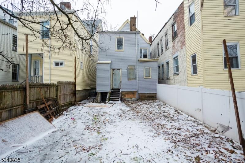 back of house featuring entry steps and a fenced backyard