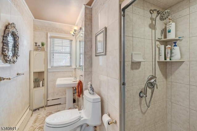 full bath with tile walls, toilet, baseboard heating, ornamental molding, and a shower stall