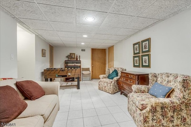 living room featuring a paneled ceiling, light tile patterned floors, and recessed lighting