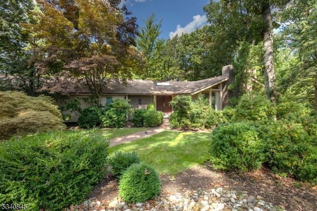 exterior space with a lawn and a chimney