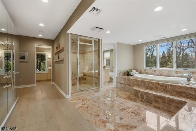 full bath featuring a garden tub, toilet, visible vents, and a shower stall