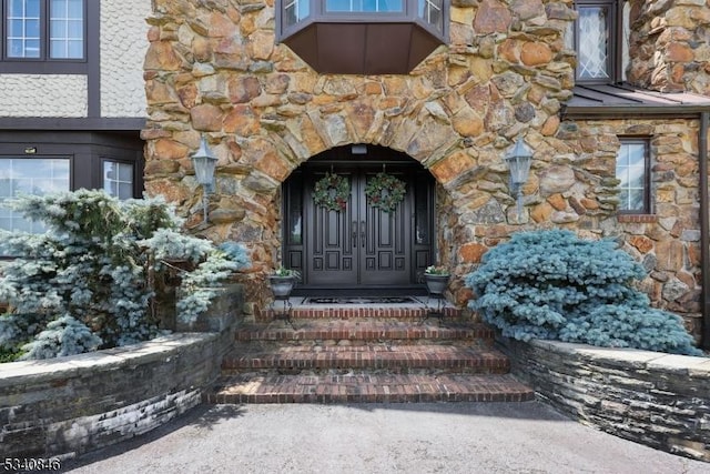 property entrance with stone siding