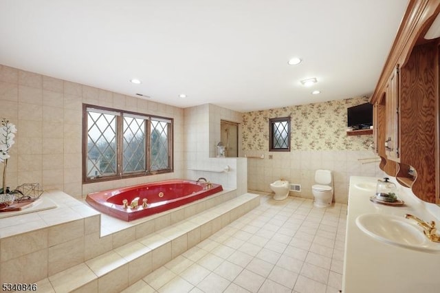 full bathroom featuring tile patterned flooring, toilet, a sink, tile walls, and wallpapered walls