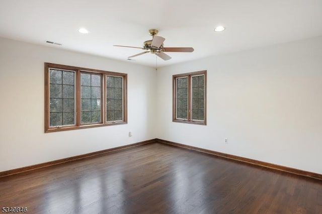 unfurnished room featuring recessed lighting, wood finished floors, visible vents, and baseboards